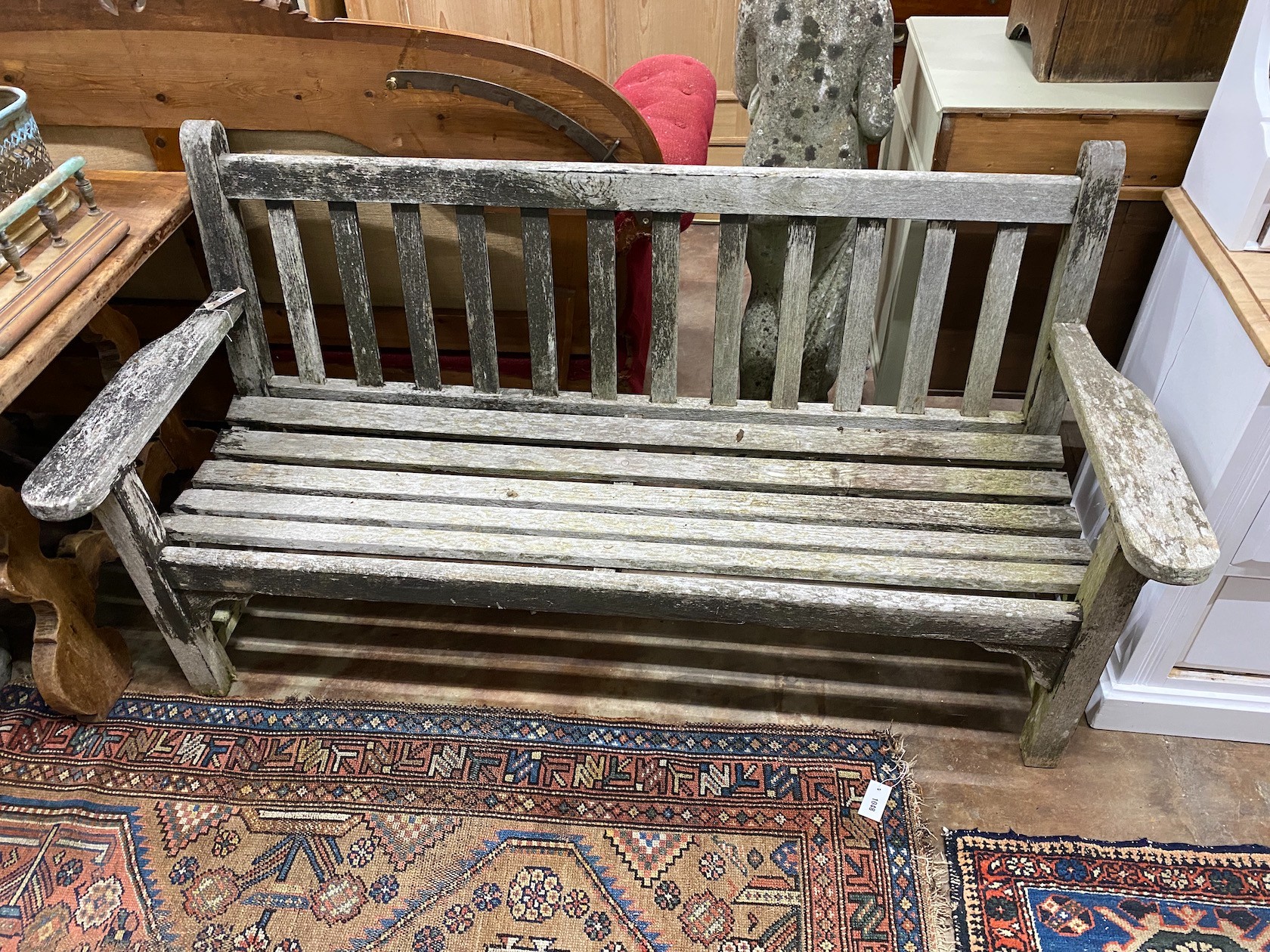 A weathered teak garden bench, width 162cm